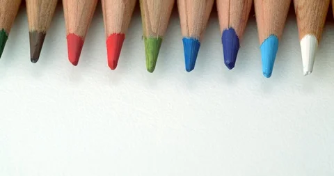 Various colour pencils rolling onto top of frame Stock Footage 113142803
