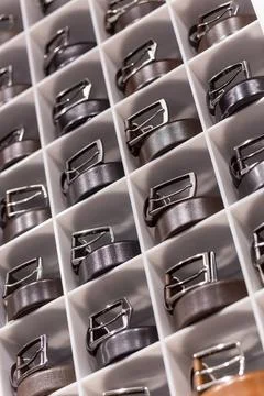 Various coloured leather belt display on shelf in the store in a men clothing Stock Photos