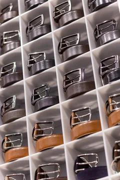 Various coloured leather belt display on shelf in the store in a men clothing 写真素材