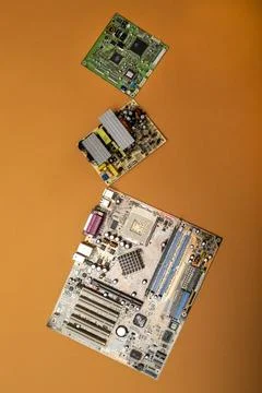 Various computer circuit boards on a colored background, top view Stock Photos