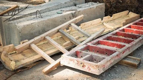 Various construction materials are scattered on the ground, including wooden  스톡 사진