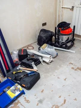 Various construction tools on floor of room Stock Photos