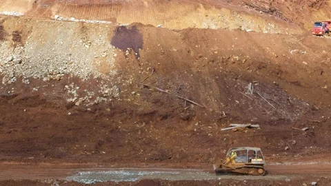 Various construction vehicles and trucks are busy at the construction site Stock Footage 132080657