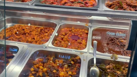 Various cooked traditional dishes displayed at local eatery Stock Footage 340479823