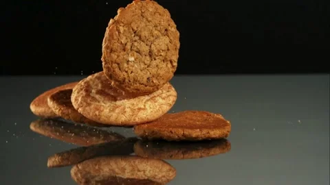 Various cookies falling on black mirror surface Stock Footage 327051270