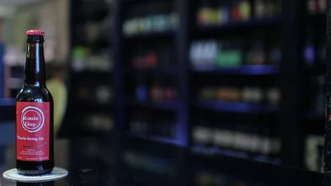 Various Craft Beer Bottles On Counter, Jump Cut Technique Vídeo Stock 344857604