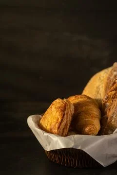 Various crusty bread in wicker basket on rustic table. Healthy eating and t.. Stock Photos