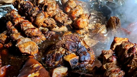 Various cuts of grilled and roasted meat sizzling and steaming on hot surface Stock Footage 313857969