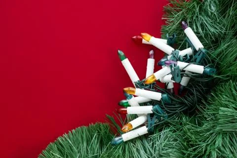 Various decorations for the Christmas tree on a red background with place for Stock Photos