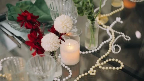 Various decorations in the form of candles and chains on the festive table Stock Footage 336272821
