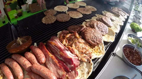 Various Delicious Meat on a Large Barbecue Hot Smoky Grill Stock Footage 67497769