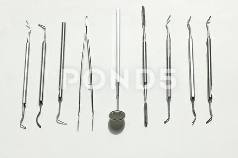 A various dental tools laid out flatlay on a light background Stock Photos