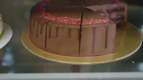 Various desserts on display in a cafe. Cakes and sweets in a pastry shop. Stock Footage 229276090