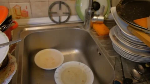Various dishes on the table, dirty plates and forks, cleaning spoons, human Stock Footage 320818786