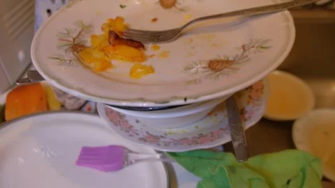 Various dishes on the table, dirty plates and forks, cleaning spoons, human Stock Footage 320862519