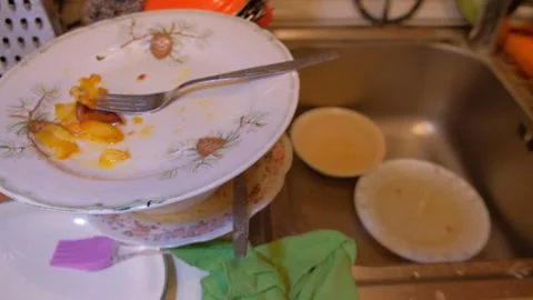 Various dishes on the table, dirty plates and forks, cleaning spoons, human Stock Footage 320862543
