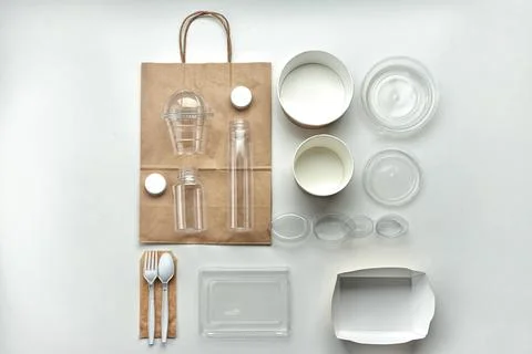 Various disposable tableware bottles and containers on a white background Stock Photos
