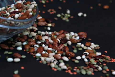 Various dried beans on the black background Stock Photos