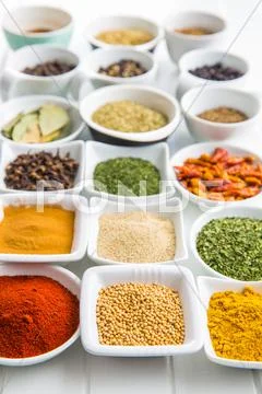 Various dried herbs and spices in bowl. Stock Photos