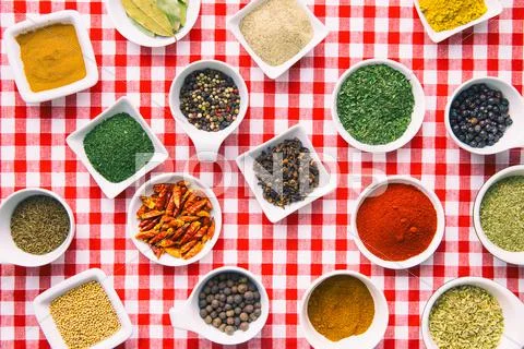 Various dried herbs and spices in bowl. Stock Photos