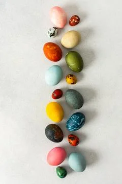 Various Easter eggs in vibrant colors and patterns are neatly arranged, showc Stock Photos