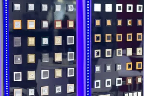 Various electrical switches and sockets on the stand in the store Stock Photos