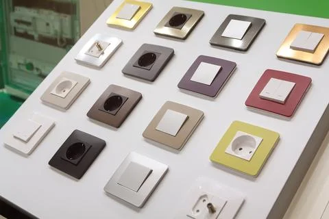 Various electrical switches and sockets on the stand in the household store Stock Photos