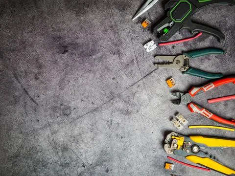 Various electrician tools on gray background with copy space. view from above Stock Photos