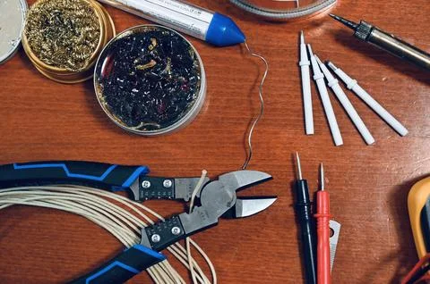 Various electronics and soldering tools including wire cutters, copper tape, and Fotos de archivo