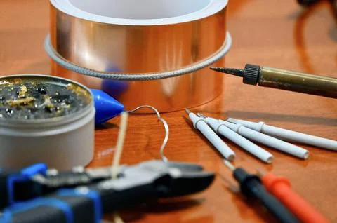 Various electronics and soldering tools including wire cutters, copper tape, and Stock Photos