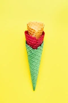 Various empty ice cream cones on a bright yellow background. Summer concept,  Foto stock
