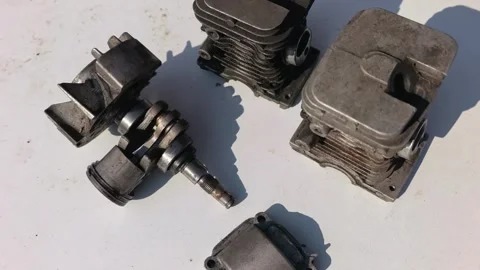 Various engine parts arranged on a flat surface in daylight showing wear and dis Stock Footage 331745103