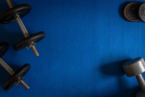 Various exercise equipment on blue background Stock Photos