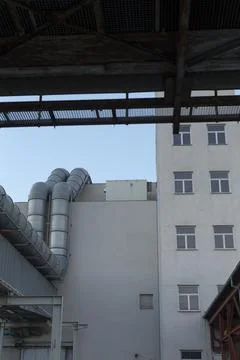 Various factory structures interconnected through icy lit walkways Stock Photos