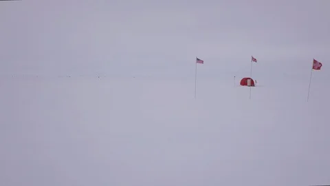 Various flags and tent on snow covered landscape Video stock 104224468