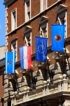 Various flags on the facade of town hall, Rijeka city, Croatia Stock Photos