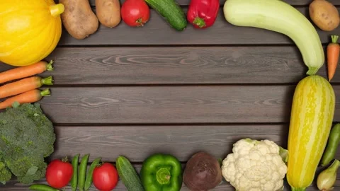 Various fresh ripe organic vegetables appear on dark wooden background Stock Footage 281768487