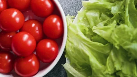 Various fresh vegetables being prepared in a kitchen setting. The clip features Stock Footage 338290265