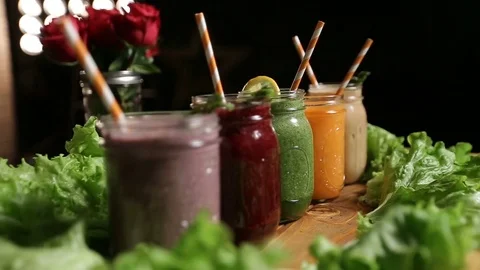 Various freshly blended smoothies on wooden tray Video stock 72732653