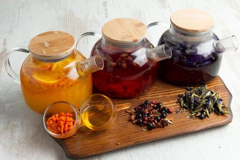 Various fruit teas in teapots Stock Photos