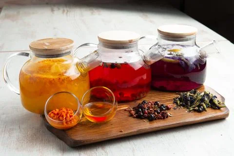 Various fruit teas in teapots Stock Photos