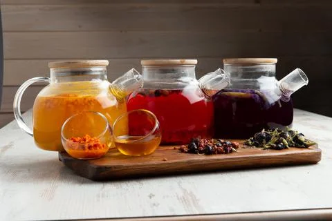 Various fruit teas in teapots Stock Photos