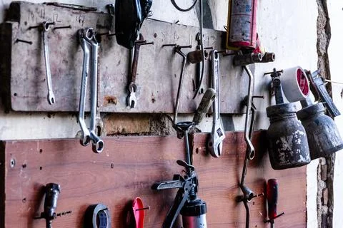 Various garage tools for a workshop for auto service and car repair hangs on  Stock Photos