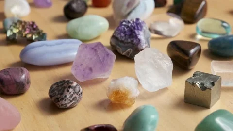 Various gem stones on a gray background Stock Footage 223668168