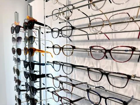 Various glasses frames on a shelf in a store Stock Photos