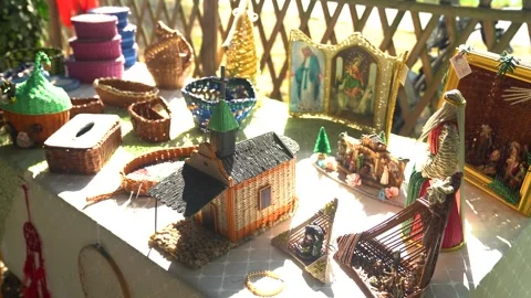 Various handmade crafts displayed on an outdoor table in warm sunlight Video stock 284304559