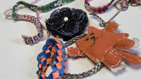 Various handmade crafts including orange fabric cat black beaded flower and.. Fotos de archivo