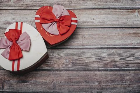 Various heart shaped boxes on an old wood background with copy space. Gift ca Stock Photos