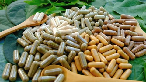 Various herbal supplement capsules. Selective focus. Stock Footage 318650990