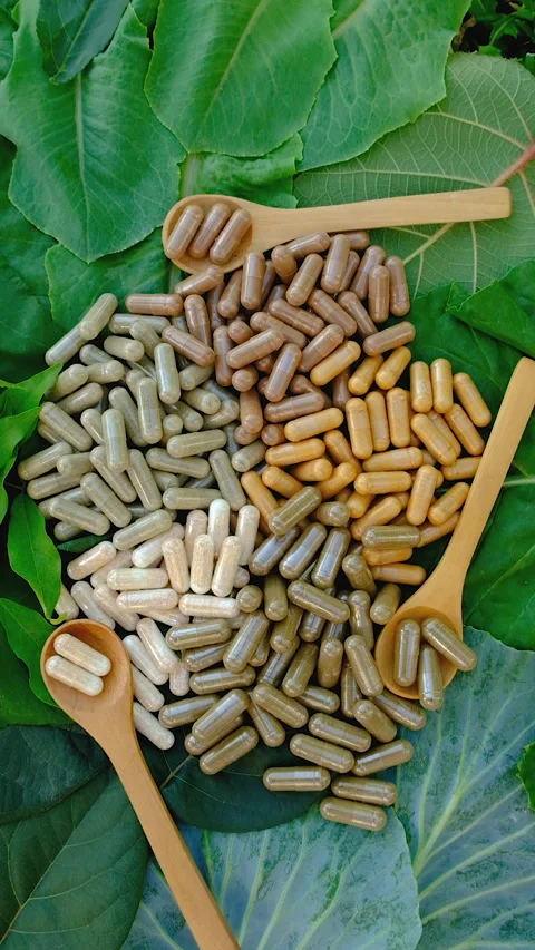 Various herbal supplement capsules. Selective focus. Stock Footage 318746005